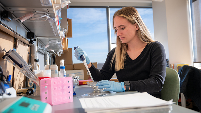student working on research in lab